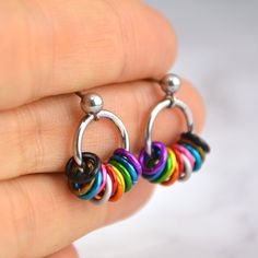 Comfortable post earrings in the vibrant colors of the lgbtq rainbow progress pride flag. These earrings are slightly larger than the minimalist tiny hoop earrings, designed specifically to accommodate the additional colors of the progress pride flag.🌈 earrings measure approximately 5/8" long from top of post🌈 aluminum and stainless steel links, and stainless steel ear postPROGRESS PRIDE colorway: black, brown, aqua, pink, white, red, orange, gold, green, blue, violet Rainbow Hypoallergenic Hoop Earrings, Hypoallergenic Rainbow Hoop Earrings, Nickel-free Small Hoop Rainbow Earrings, Adjustable Rainbow Small Hoop Earrings, Rainbow Small Hoop Earrings, Progress Pride Flag, Flag Earrings, Lgbtq Rainbow, Tiny Hoop Earrings