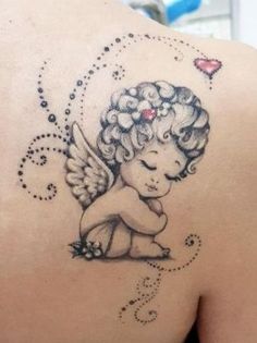 an angel tattoo on the back of a woman's shoulder