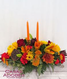 an arrangement of flowers and candles on a white background with the words cassas adores below it