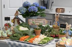 a table filled with lots of vegetables and stuffed animals