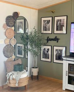 a living room with pictures on the wall and a flat screen tv in front of it