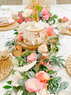 a table topped with lots of cake and flowers