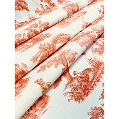 an orange and white toiler print fabric with red trees on it, as well as