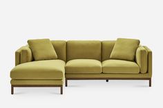 a green couch with pillows on it