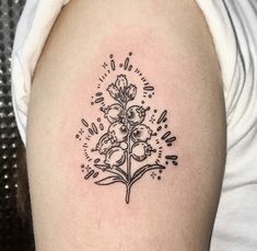 a black and white flower tattoo on the arm