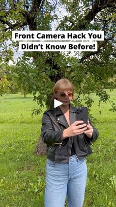 a woman standing in front of a tree holding a camera and text that reads, front camera hack you didn't know before