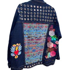 This exclusive piece, size XL, is a burst of style and personality. Hand-intervened on blue denim, each jacket is truly unique and one of a kind. I never make two jackets alike, ensuring you have a completely exclusive piece. Crafted with colorful fabrics for a unique touch, this jacket features studs, eyelets, and rings that add an extra edge of freshness and originality. While the fabric is rigid, make sure to measure yourself well: Sleeve Length: 55 cm Length: 70 cm Bust Width: 60 cm Get read Bohemian Embellished Outerwear For Spring, Bohemian Embellished Spring Outerwear, Embellished Denim Outerwear For Festivals, Embellished Long Sleeve Denim Jacket For Festival, Bohemian Embellished Denim Jacket For Fall, Bohemian Embellished Denim Jacket, Jackets With Fringe, Lace And Beads, Embellished Denim