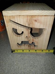 a wooden box with a face drawn on it