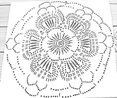 an intricate doily is shown in black and white on a wooden tablecloth, which has been cut into smaller circles