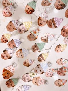 a group of children's faces are displayed on a table with paper bunting