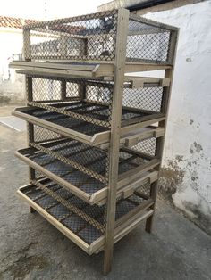 three tiered wooden shelf with wire mesh on top