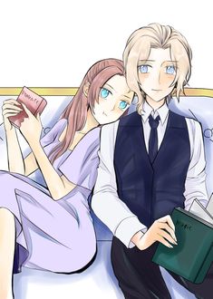 two people are sitting on a couch and one is holding a book while the other looks at something