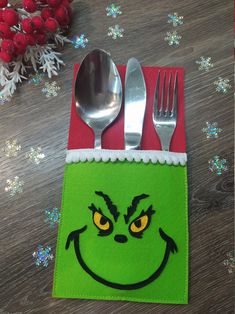 a grin face napkin with silverware on it