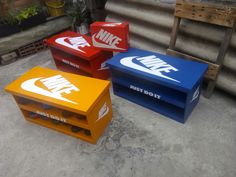 three colorful nike boxes sitting on the ground