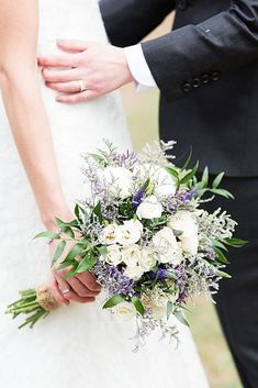 the bride and groom are holding their wedding bouquet