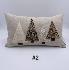 a pillow with three trees on it and the number two is in front of it