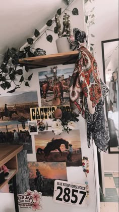 a refrigerator covered in pictures and magnets next to a potted plant on top of a wooden shelf