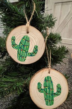 two wooden ornaments with green cactus designs on them