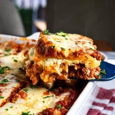 a close up of a plate of lasagna casserole with meat and cheese