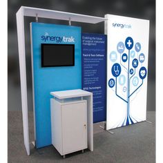 an exhibit booth with a blue and white sign next to it that says synsytrak