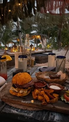 a table topped with lots of food on top of a wooden table covered in candles