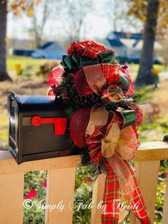 a mailbox decorated with red and green ribbons