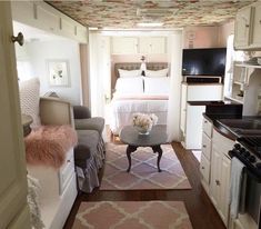 a living area with a couch, coffee table and bed