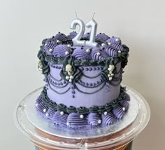 Celebration goth-style birthday cake in purple lavender and black with vintage-style buttercream piping decoration all over, dotted with small skulls and silver sprinkles. The three layer cake is topped with silver number 21 candles. Purple And Black Halloween Birthday Cake, Pastel Goth Cake, Black And Purple Birthday Cake, Gothic Cake Birthday, Purple Halloween Cake, Purple And Black Cake, Witch Birthday Cake, Purple Bday Cake, Goth Birthday Cake