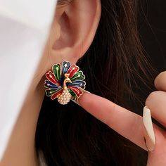 ✦ Looking to celebrate and throw a party? Our fantastic color peacock stud earrings are sure to make a statement. Peacocks symbolize mystery and pride, and these earrings capture that essence perfectly. When you adorn yourself with these peacock earrings, you become a captivating presence, catching everyone's attention in an instant. ----------- DESCRIPTIONS ----------- - SKU: WE120- Materials: Copper, 925 Sterling Silver, Enamel, Faux Pearl- Pendant Size(Length* Width): 2.5cm*2.5cm Luxury Peacock Design Earrings For Festive Occasions, Luxury Peacock Design Earrings For Celebration, Luxury Peacock Design Earrings For Festivals, Color Peacock, Peacock Earrings, Elegant Gothic, Nose Rings Hoop, Crystal Hoop Earrings, Throw A Party