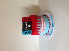 a birthday cake made to look like a roll of toilet paper with dices on it