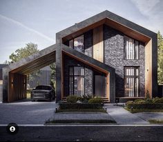 a car is parked in front of a two story house with large windows and wooden accents