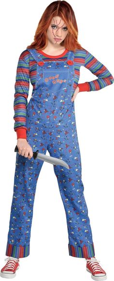 a woman with red hair wearing blue pajamas and holding a knife in one hand while standing up