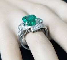 Gorgeous Vintage Diamond & Emerald in Platinum ring circ 1920's center set natural Colombia emerald weight 4.43ct size 11.1x9.3mm GIA cert. Has a nice rich green color ,brilliant clean very lively stones. Side Set two Natural old mine cut Diamonds Weight 0.50ct. Size 4mm SI1 -G lively brilliant, clean white bright stones. Side set small diamonds weight 0.25ct. Ring size 7.5 Resizable This tremendous old vintage ring is in a very good condition. Retail value $18,500 net. Appraisal available Gia Certified Art Deco Emerald Ring, Art Deco Emerald Ring With Diamond Accents, Art Deco Collectible Emerald Ring, Art Deco Filigree, Filigree Engagement Ring, Emerald Diamond Ring, Rich Green, 18k Gold Ring, Platinum Ring