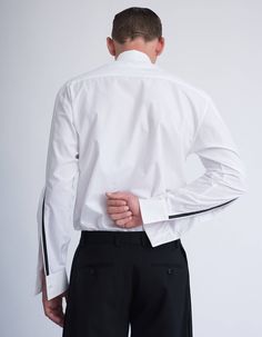 This minimal designed shirt has an emphasis on silhouette, it has a roomy shape enhanced by the dropped shoulder seams and squared hem. It has a two piece sleeve with a deep placket detailed with a fine contrasting gross grain ribbon. The exaggerated sleeves proportions give this oversized shirt it's modern and edgy look. This shirt is made from a crisp white cotton poplin and would easily become your wardrobe key item. It’s the perfect piece to dress an outfit up or down with minimal effort - i Modern Office Shirt, Modern Office Shirt With Concealed Placket, Button Shirts Men, Exaggerated Sleeves, Best Dressed Man, Formal Pants, Mens Luxury Fashion, Mens Designer Fashion, Edgy Look