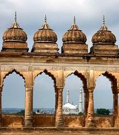 an old building with arches and domes on top