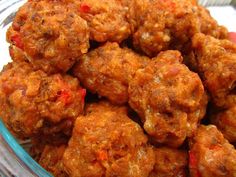 a bowl filled with meatballs sitting on top of a table