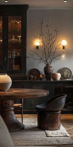 a dining room table and chairs in front of a hutch with lights on it