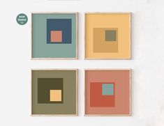 four square paintings mounted on a wall