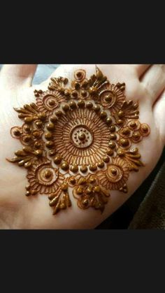 a woman's hand with henna on it