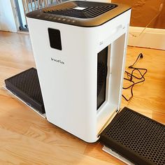 a white computer case sitting on top of a hard wood floor