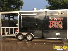 the bbq trailer is parked on the side of the road