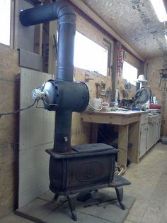 an old fashioned stove is in the middle of a room with unfinished walls and flooring