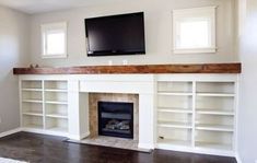 an empty living room with a fireplace and flat screen tv mounted above the mantel