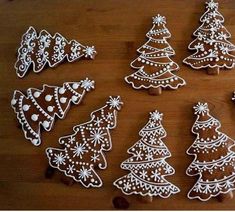 decorated cookies are arranged on a wooden table