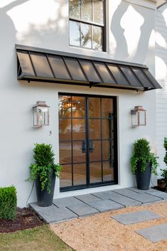 an image of a white house with black doors