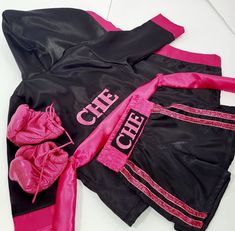 two pink and black clothing laying on top of each other