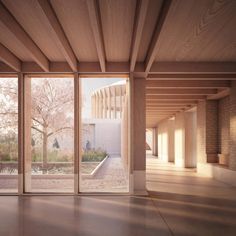 an empty room with large windows and wooden beams on the ceiling is lit by sunlight coming through glass doors