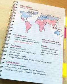 a notebook with writing on it and a world map