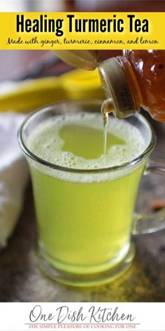 a person pouring tea into a glass cup