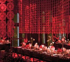 a long dining table is set with flowers and candles